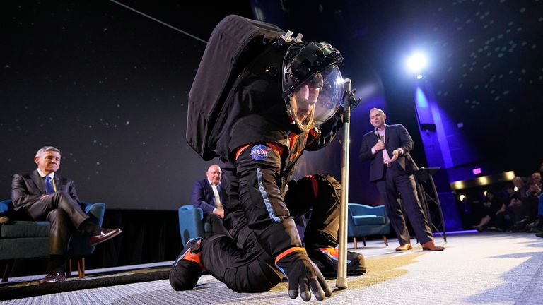 Axiom Space Chief Engineer Jim Stein demonstrates a prototype spacesuit.  photo: AP