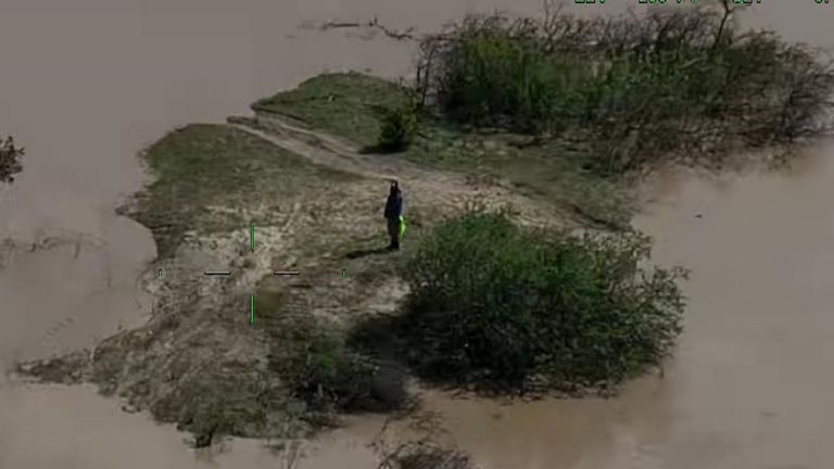 Driver stranded in flooded river is rescued