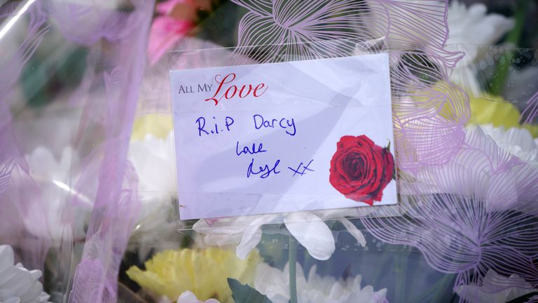 A message left with floral tributes left near the scene in the St Mellons area of Cardiff where three people who disappeared on a night out have died in a road traffic accident. Two others who had also been reported missing have been transported to hospital with serious injuries. Sophie Russon, 20, Eve Smith, 21, and Darcy Ross, 21, who had made the trip from Porthcawl, and Rafel Jeanne, 24, and Shane Loughlin, 32, both from Cardiff, had last been seen in the city in the early hours of Saturday.