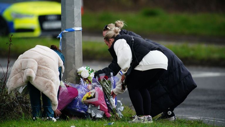 People lay flowers near the scene