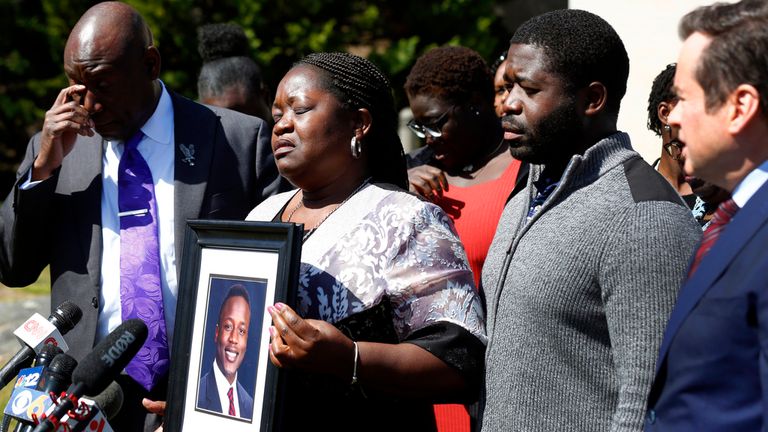 Caroline Ouko, mother of Irvo Otieno, holds a portrait of her son with attorney Ben Crump, left, her older son, Leon Ochieng and attorney Mark Krudys at the Dinwiddie Courthouse in Dinwiddie, Va., on Thursday, March 16, 2023. There is goodness in his music and that&#39;s all I&#39;m left with now ... he&#39;s gone,... Otieno&#39;s mother, Caroline Ouko, said at the news conference while clutching a framed photo of her son. (Daniel Sangjib Min/Richmond Times-Dispatch via AP)