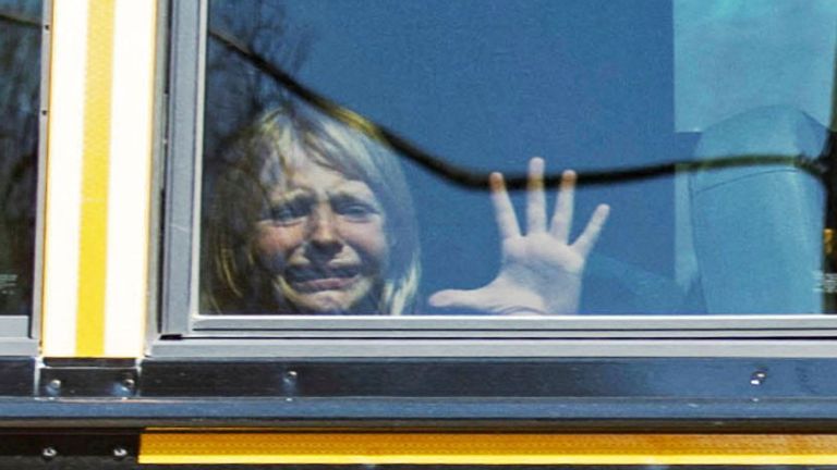 A child cries while on the bus leaving the Covenant School, following a mass shooting