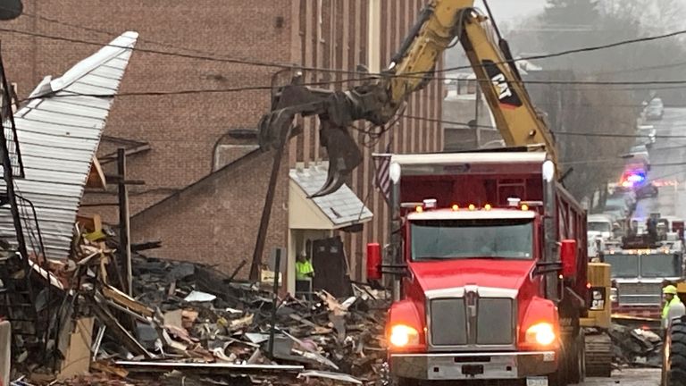 Rubble is cleared at the site of a deadly explosion at a chocolate factory