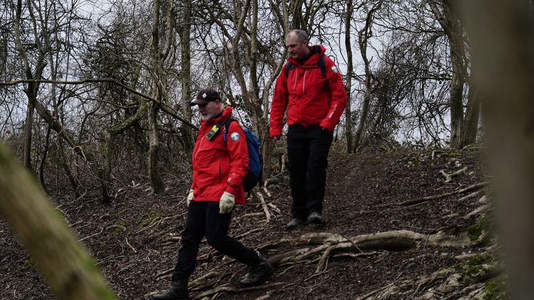 Police officers and officers from London Search and Rescue (LONSAR) in woodland at Wild Park Local Nature Reserve