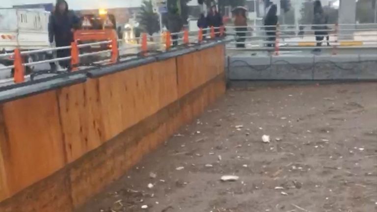 People stand near the underpass that got flooded following torrential rains, in Sanliurfa, Turkey March 15, 2023, in this screen grab obtained from a social media video. Esat Baran/via REUTERS THIS IMAGE HAS BEEN SUPPLIED BY A THIRD PARTY. MANDATORY CREDIT. NO RESALES. NO ARCHIVES.