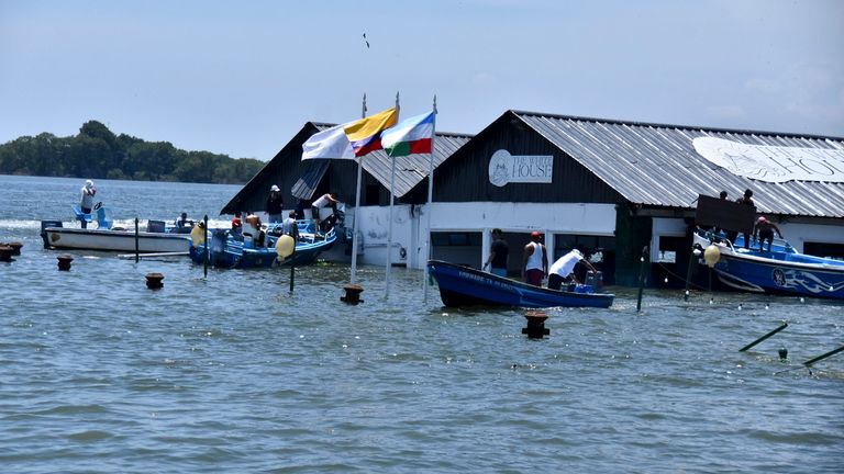 The Marine Museum of Puerto Bolivar, detached from the dock, is partially inundated in water after an earthquake that shook Machala, Ecuador, Saturday, March 18, 2023. The U.S. Geological Survey reported an earthquake with a magnitude of about 6.8 that was centered just off the Pacific Coast, about 50 miles (80 kilometers) south of Guayaquil. (AP Photo/Jorge Sanchez)