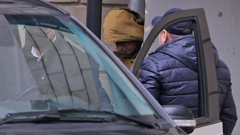 Evan Gershkovich leaves a court building in Moscow