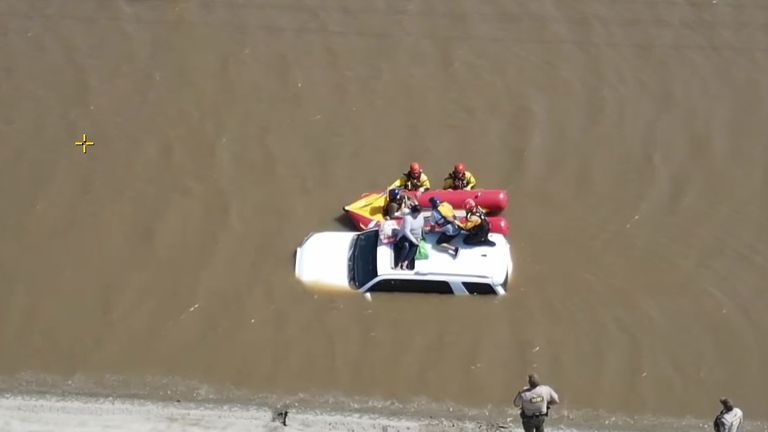 Group rescued from car roof in California
