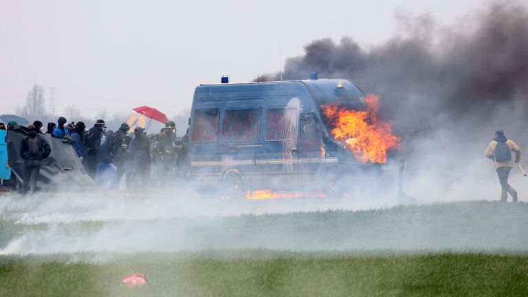 A gendarmerie vehicle burns during a demonstration called by the collective "Bassines Non Merci" against the "basins" on the construction site of new water storage infrastructure for agricultural irrigation in western France, in Sainte-Soline, France March 25, 2023. REUTERS/Yves Herman