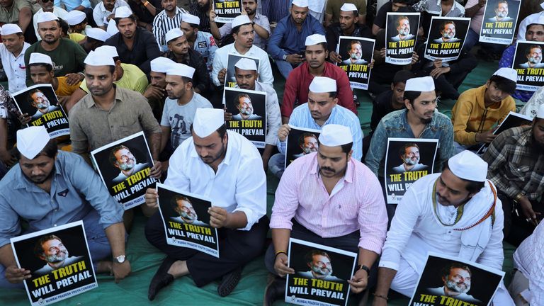 Supporters of the Youth Congress Party hold placards during a silent protest against the conviction of Rahul Gandhi in Mumbai