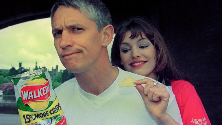 Model Kelly Brook, who turns the tables on former England soccer star Gary Lineker by pinching one of his crisps, at the Walkers Crisps 50th Birthday bash at Alton Towers, where they were hosts for the day.