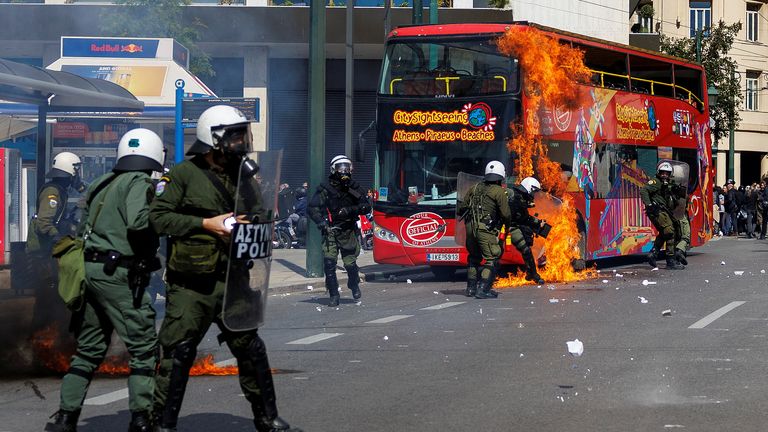 A petrol bomb explodes next to riot police as clashes take place during a demonstration following the collision of two trains, near the city of Larissa, in Athens, Greece, March 5, 2023. REUTERS/Alkis Konstantinidis