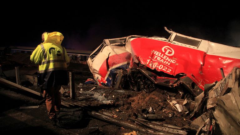 A man walks at the site of a crash, where two trains collided, near the city of Larissa, Greece, March 1, 2023. REUTERS/Kostas Mantziaris NO RESALES. NO ARCHIVES.