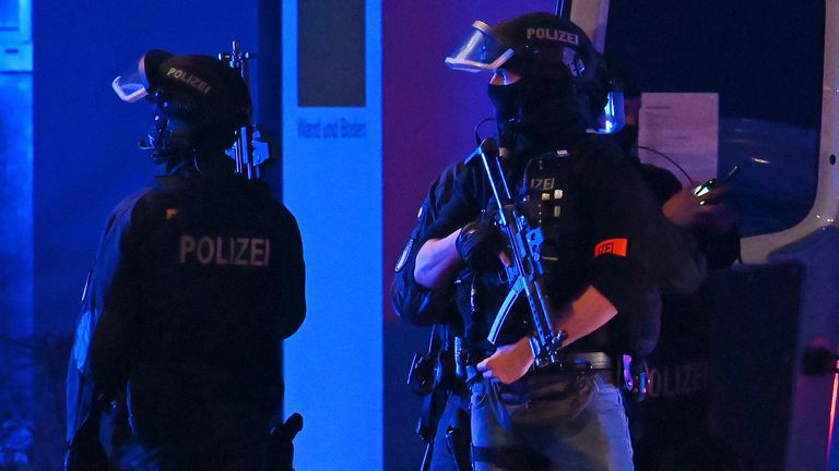 Armed police officers near the scene. Pic: Jonas Walzberg/dpa via AP