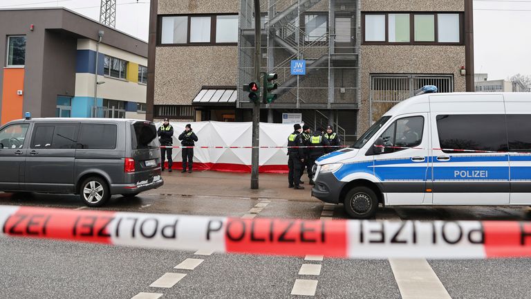Hamburg police guarding a Jehovah&#39;s Witnesses building where a shooting left several people dead. Pic: AP