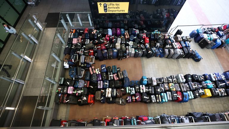 Lines of passenger luggage lie outside Terminal 2 at Heathrow Airport, June 2022.