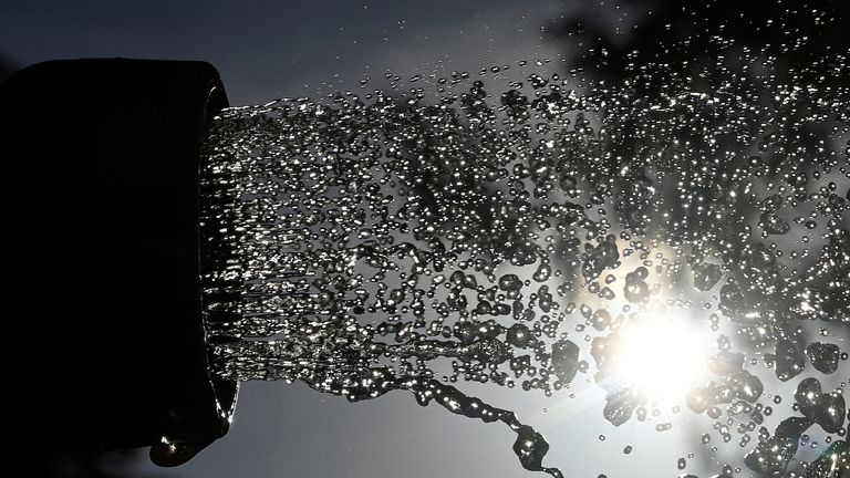 A garden hosepipe is seen in use ahead of regional restrictions over water usage being implemented, in this picture illustration taken in London, Britain, August 4, 2022. REUTERS/Toby Melville
