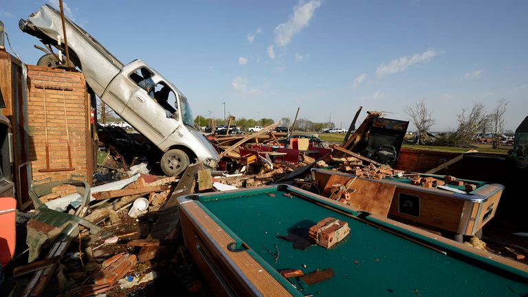 A pickup truck sits on top of a restaurant cooler at Chuck's Dairy Cafe in Rolling Fork, Mississippi, Saturday, March 25, 2023. Tornadoes that tore through the state on Friday night killed several people, emergency officials in Mississippi said, as severe weather produced golf ball-sized hail that tore through several southern states, destroying buildings and knocking out power.  (AP Photo/Rogelio V. Solis)