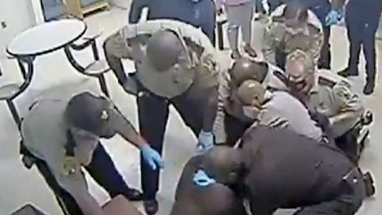 In this March 6, 2023, still image from video surveillance at Central State Hospital in Petersburg, Virginia, U.S., a Virginia sheriff's deputies wrestle with Irvo Otieno, a 28-year-old black man, before his death at the state psychiatric facility. Handout by Dinwiddie County U.S. Attorney's Office/REUTERS This image was provided by a third party.