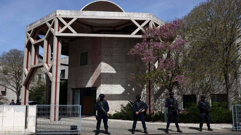 Police officers stand guard outside the Ismaili centre in Lisbon, Portugal