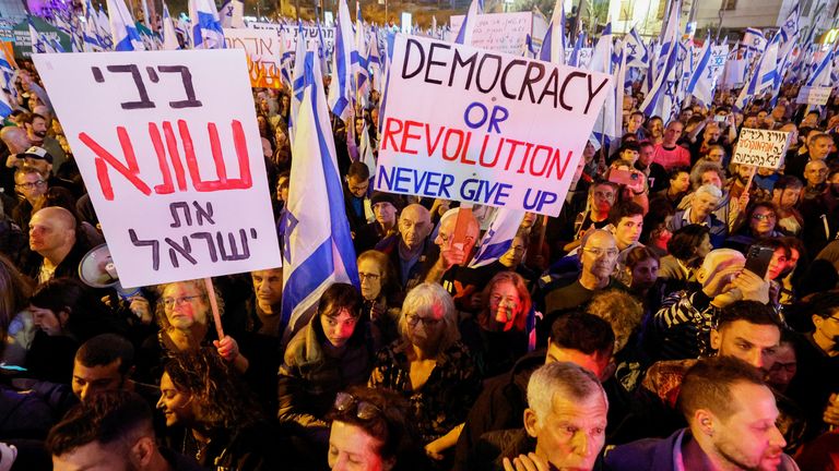 People hold placards and flags during a demonstration as Israeli Prime Minister Benjamin Netanyahu&#39;s nationalist coalition government presses on with its contentious judicial overhaul, in Tel Aviv, Israel March 4, 2023. REUTERS/Amir Cohen