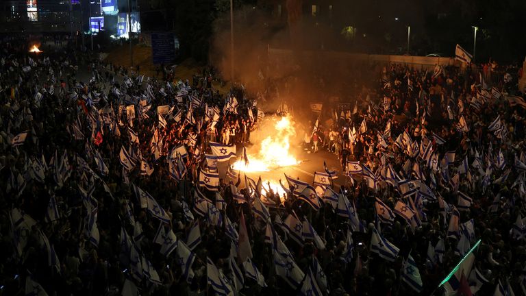 People attend a demonstration after Israeli Prime Minister Benjamin Netanyahu dismissed the defense minister and his nationalist coalition government presses on with its judicial overhaul, in Tel Aviv, Israel, March 26, 2023. REUTERS/Nir Elias