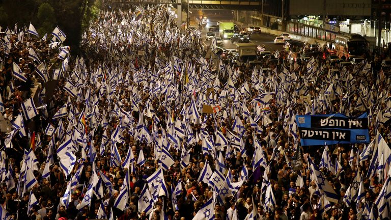 People attend a demonstration after Israeli Prime Minister Benjamin Netanyahu dismissed the defense minister and his nationalist coalition government presses on with its judicial overhaul, in Tel Aviv, Israel, March 26, 2023. REUTERS/Nir Elias