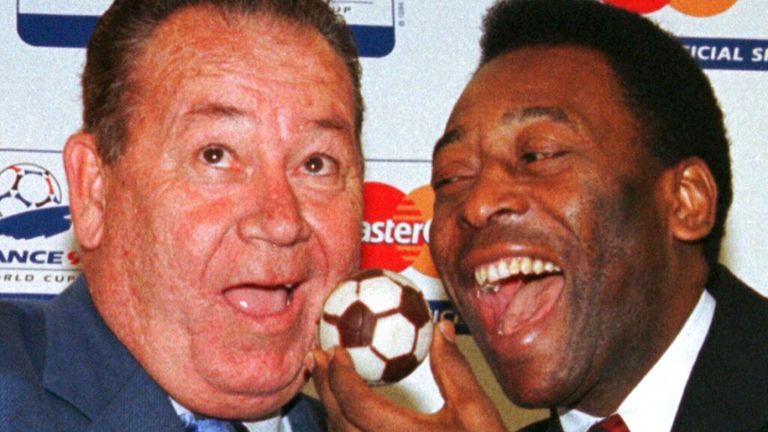 Pele, of Brazil, feeds French soccer legend Just Fontaine, left, with a soccer ball cake Sunday, July 5, 1998 in Paris.French soccer great Just Fontaine, whose 1958 record of 13 goals scored during a World Cup still stands, has died. He was 89. His former club Reims announced Fontaine&#39;s death on Wednesday March 1, 2023. (AP Photo/Jacques Brinon, File)
