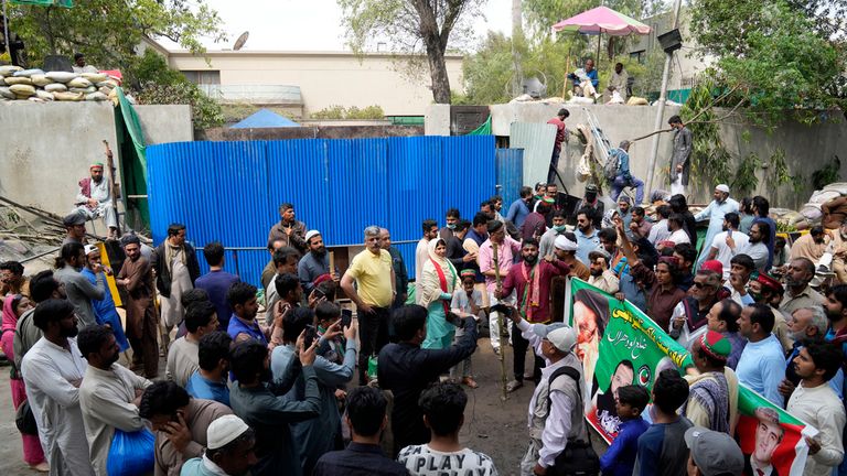 People gathered outside the Khan house on Sunday