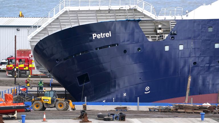 Emergency services at Imperial Dock in Leith, Edinburgh, where a ship has become dislodged from its holding and is partially toppled over. Picture date: Wednesday March 22, 2023.