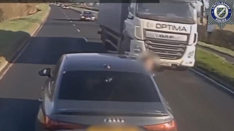 An Audi driver nearly collides with an oncoming lorry in dashcam footage shared by Lancashire Police.