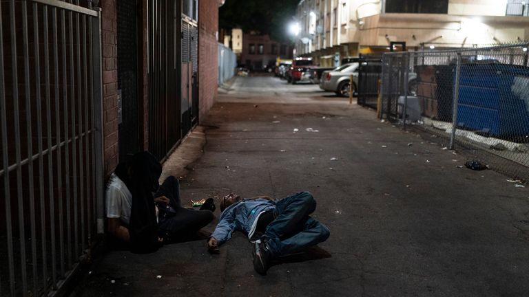 Two addicts sleep in an alley in Los Angeles, Wednesday, Sept. 21, 2022. Nearly 2,000 homeless people died in the city from April 2020 to March 2021, a 56% increase from the previous year, according to a report released by the Los Angeles County Department of Public Health. Overdose was the leading cause of death, killing more than 700. (AP Photo/Jae C. Hong)