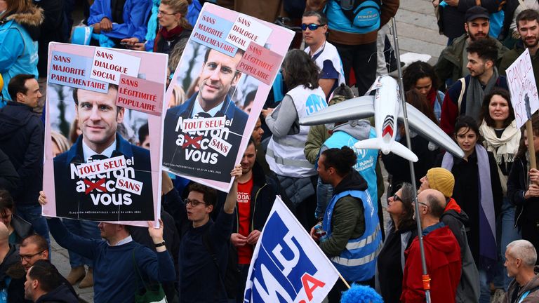 Protesters hold placards with a portrait of French President Emmanuel Macron during a demonstration as part of the ninth day of nationwide strikes and protests against French government&#39;s pension reform, in Paris, France, March 23, 2023. REUTERS/Yves Herman
