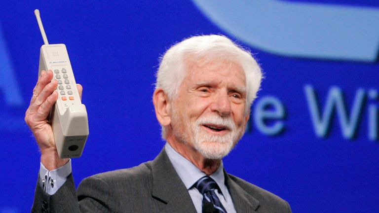Martin Cooper holds a replica of the first cellular phone at CTIA Wireless 2008 in Las Vegas, Nevada April 2, 2008. Martin, a general manager of Motorola&#39;s Communications Systems Division at the time, is credited with making the first public telephone call placed on a portable cellular phone on April 3, 1973. REUTERS/Steve Marcus (UNITED STATES)