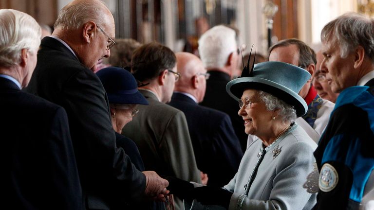 Queen Elizabeth II, distributes Maundy money to a pensioner in 2010