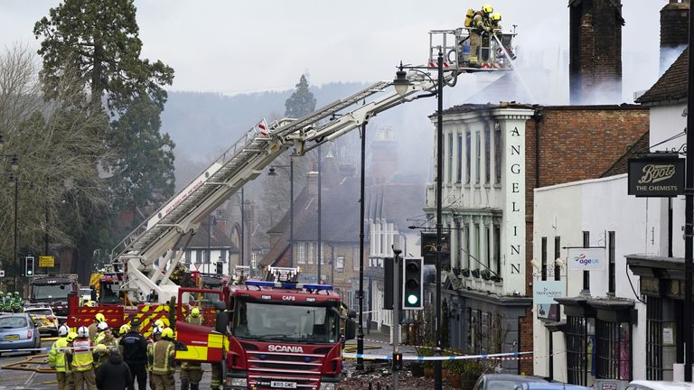 Firefighters dealing with a fire in Midhurst, West Sussex which includes a 400-year-old hotel that was said to be housing Ukrainian refugees. The fire was thought to have broken out shortly after 1am on Thursday at a property on North Street before spreading to the roof of the Angel Inn next door. Picture date: Thursday March 16, 2023.
