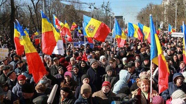 People wave flags during a protest in Moldova