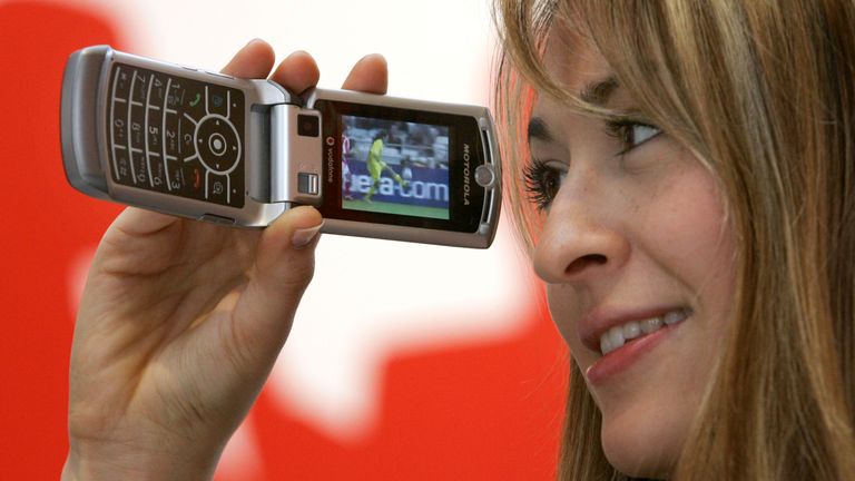 A model demonstrates TV services on a Motorola RAZR V3x mobile phone with UMTS capabilities provided by Vodafone at the CeBIT computer exhibition in the northern German town of Hannover, March 7, 2006. CeBIT, the world's largest computer and information technology exhibition, will be held from March 9th to March 15th, 2006. REUTERS/Fabrizio Bensch