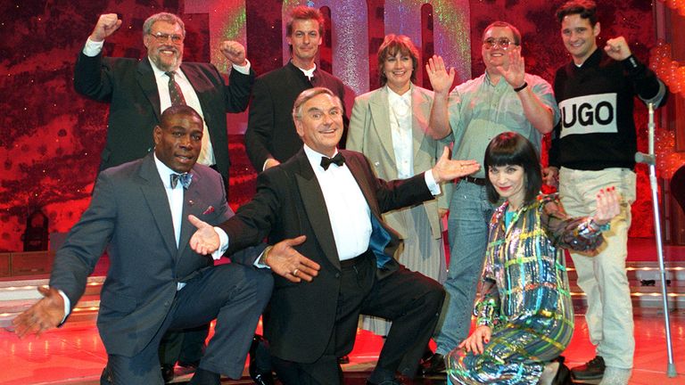 File photo dated 12/10/96 of the then National Lottery presenters, (left to right front row) Frank Bruno, Bob Monkhouse and Mystic Meg, celebrating the 100th jackpot draw with past winners (back left to right) Bob Westland (3.7m), Ken Southwell (900,000), Elaine Thompson (2.7m), Peter Lavery (10.2m) and Karl Crompton (10.9m). Mystic Meg, The Sun&#39;s longtime astrologer, has died aged 80, according to the newspaper. 