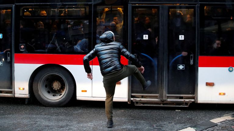 An Eintracht Frankfurt fan kicks a bus ahead of a UEFA Champions League soccer match between Napoli and Eintracht Frankfurt in Naples, Italy, March 15, 2023. REUTERS/Stringer