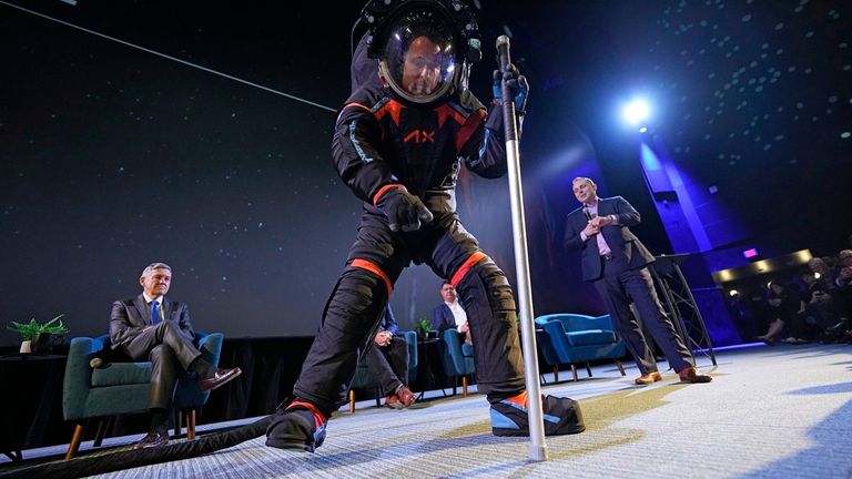 Axiom Space chief engineer Jim Stein demonstrates a prototype spacesuit, Wednesday, March 15, 2023, in Houston. NASA selected Axiom Space to design the spacesuits that its moonwalking astronauts will wear when they step onto the lunar surface later this decade. (AP Photo/David J. Phillip)