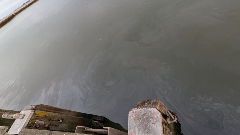 An image shows leaked fluid on the surface of the water in Dorset. Pic: Chris Miller