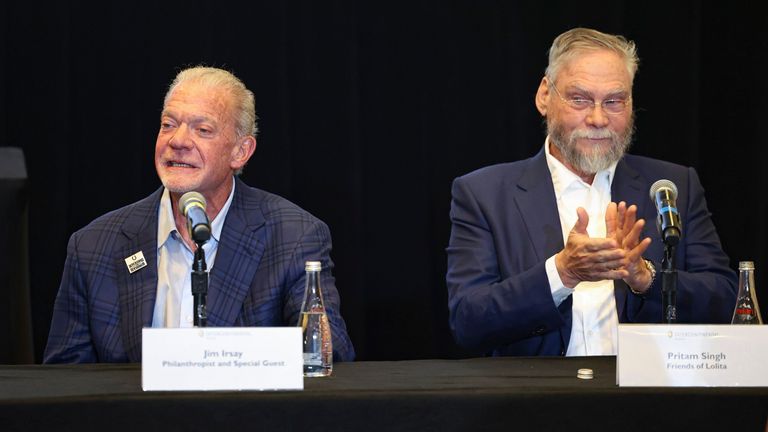 Jim Irsay, CEO of the Indianapolis Colts, left, talks as Pritam Singh, Friends of Lolita, claps during a press conference to discuss the future of Lolita, an orca that has lived at the Miami Seaquarium for more than 50 years, Thursday, March 30, 2023, at the Intercontinental hotel in Miami. An unlikely coalition of a theme park owner, animal rights group and NFL owner-philanthropist announced Thursday that a plan is in place to return Lolita to her home waters in the Pacific Northwest. (Alie Skowronski/Miami Herald via AP)