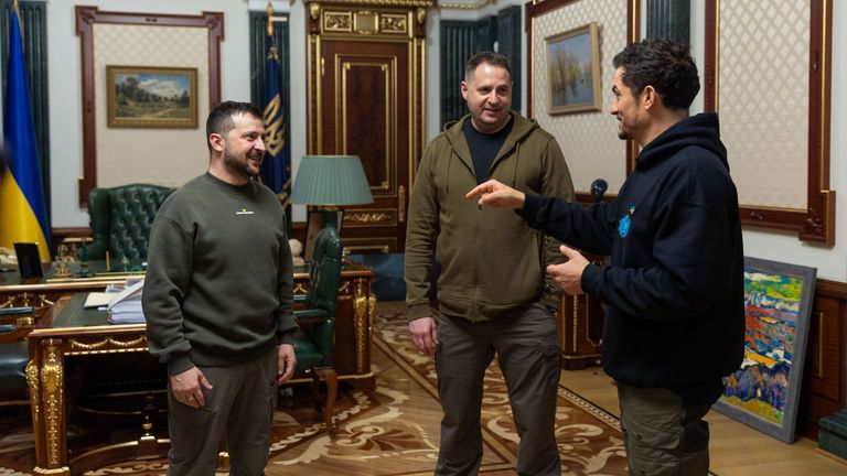 Mr Zelenskyy (L) and the Head of the President's Office, Andriy Yermak (C) speaking with the actor