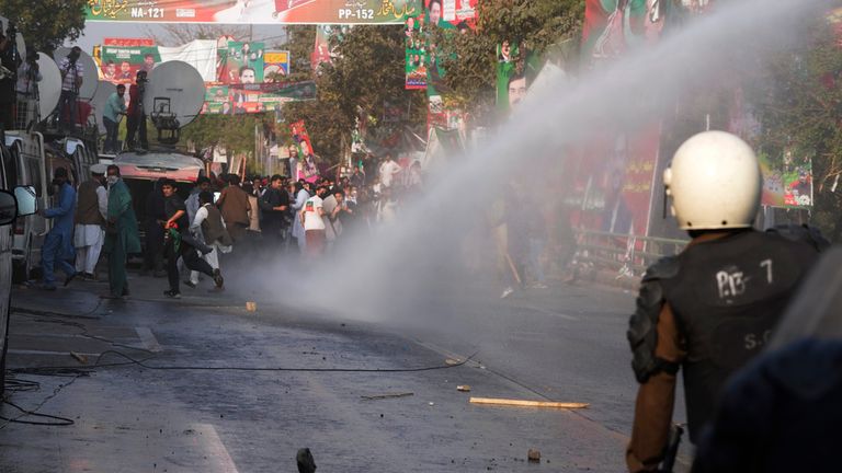 Police use a water cannon to disperse the supporters of former Prime Minister Imran Khan during clashes. Pic: AP