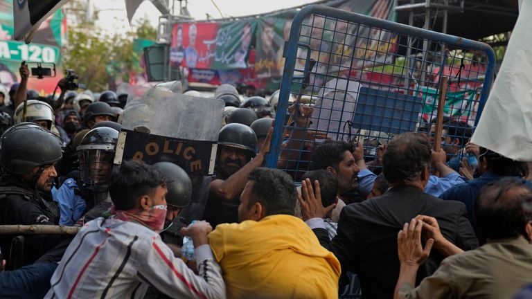 Supporters of former Prime Minister Imran Khan&#39;s party scuffle with riot police officers outside Khan&#39;s residence, in Lahore, Pakistan, Tuesday, March 14, 2023. Pakistani police scuffled with supporters of former Prime Minister Imran Khan as officers arrived outside his home to arrest him for failing to appear in court on graft charges, police and officials said. (AP Photo/K.M. Chaudary)