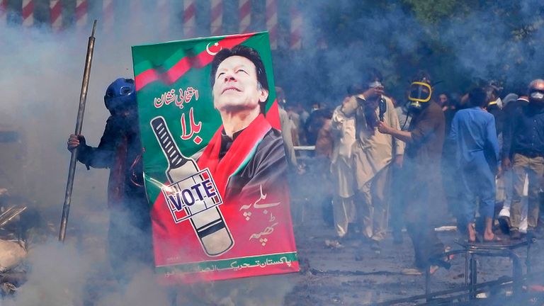 Mr Khan&#39;s supporters threw bricks and stones at police who fired tear gas. Pic: AP