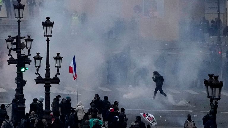 Protesters scuffle at the end of a rally in Paris Pic: AP 