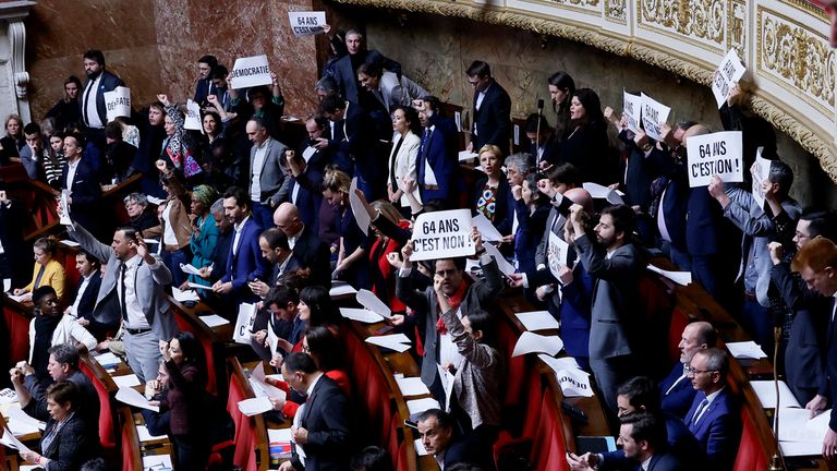Far-left lawmakers react as they holds paper reading. Pic:AP 