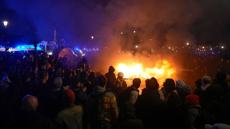Demonstrators gather next to a burning barricade as they stage a protest in Paris, Friday, March 17, 2023. Pic: AP